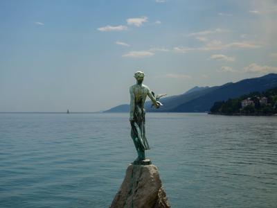 Scenic view of the iconic Maiden with the Seagull statue in Opatija, Croatia, overlooking the Adriatic Sea.