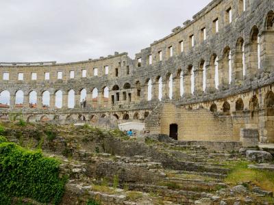 Explore the historic Roman amphitheater ruins in Pula, a major tourist attraction in Croatia.
