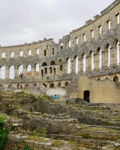 Explore the historic Roman amphitheater ruins in Pula, a major tourist attraction in Croatia.