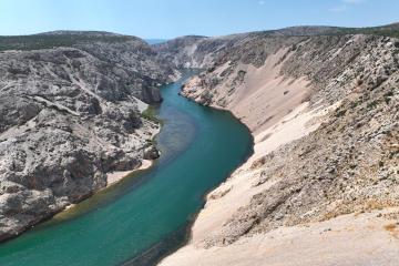 Free Stunning aerial view of the Zrmanja River winding through a rocky canyon under a clear blue sky. Stock Photo