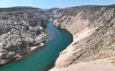 Free Stunning aerial view of the Zrmanja River winding through a rocky canyon under a clear blue sky. Stock Photo