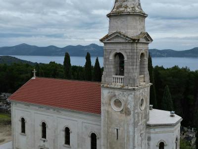 Aerial view of a historic church in the serene landscape of Zadar, Croatia.
