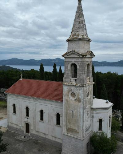 Aerial view of a historic church in the serene landscape of Zadar, Croatia.