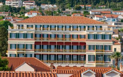 Stunning facade of a luxury hotel in Dubrovnik, showcasing classic architecture under a summer sky.