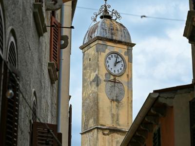 Scenic view of the historic clock tower in Labin, Croatia with surrounding architecture.