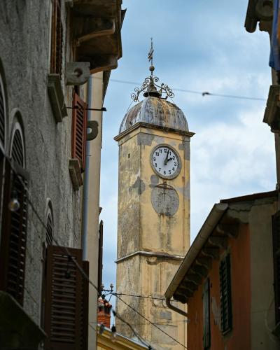 Scenic view of the historic clock tower in Labin, Croatia with surrounding architecture.