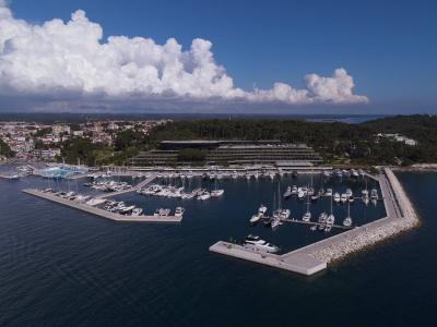 Stunning aerial view of the marina in Rovinj, Croatia featuring sailboats and yachts on a sunny day.