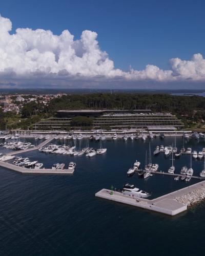 Stunning aerial view of the marina in Rovinj, Croatia featuring sailboats and yachts on a sunny day.