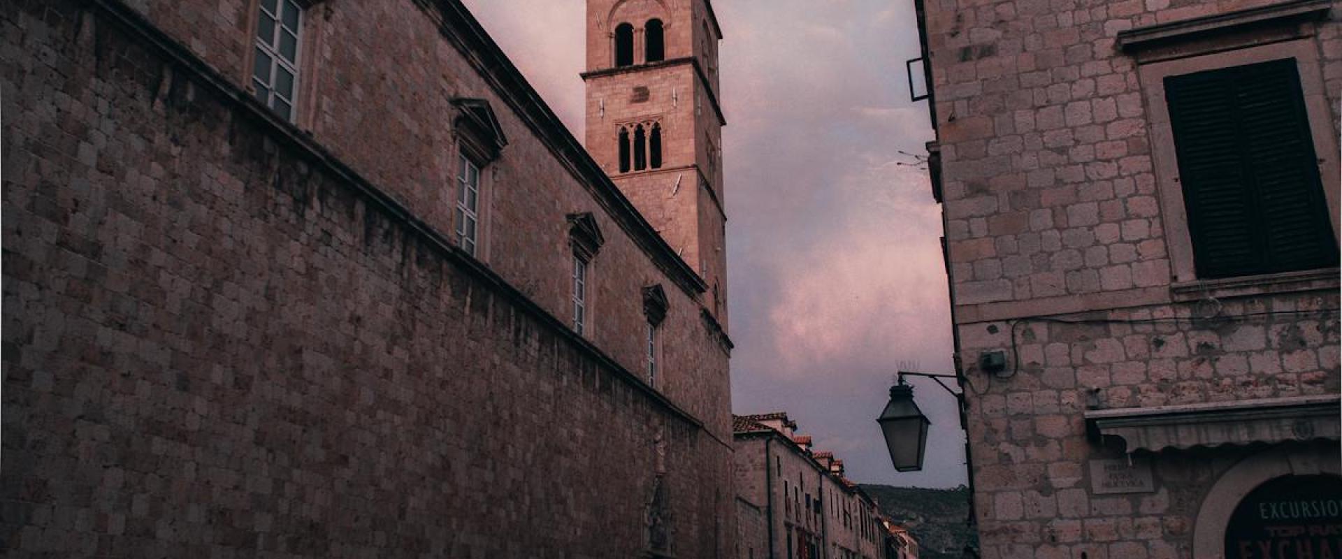 Dramatic skyline over a bustling street beside historic Croatian architecture. Captivating twilight setting.