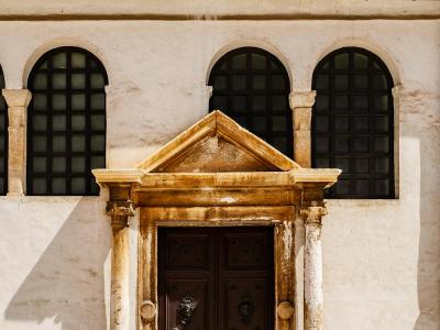 Ornate stone doorway of a historic church in sunny Zadar, Croatia.