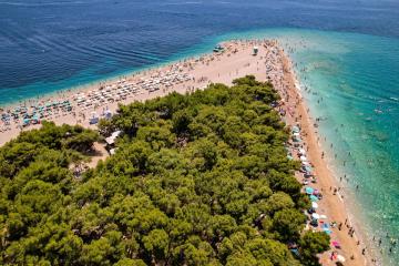 Free Stunning aerial view of the famous Zlatni Rat Beach with turquoise waters, ideal for summer vacations. Stock Photo