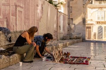 Artisans displaying handcrafted goods in historic Split, Croatia.