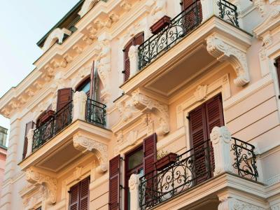 Stunning view of elegant Croatian architecture in Opatija, showcasing ornate balconies and sunset lighting.