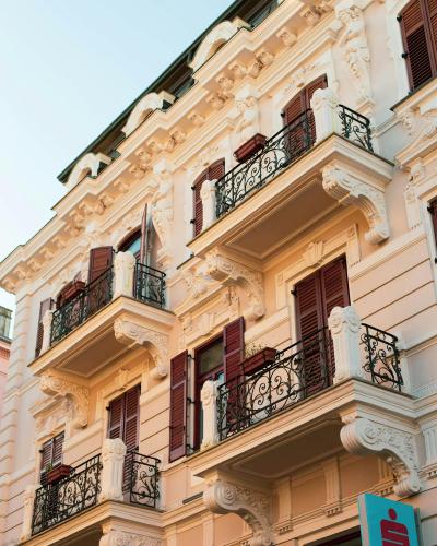 Stunning view of elegant Croatian architecture in Opatija, showcasing ornate balconies and sunset lighting.