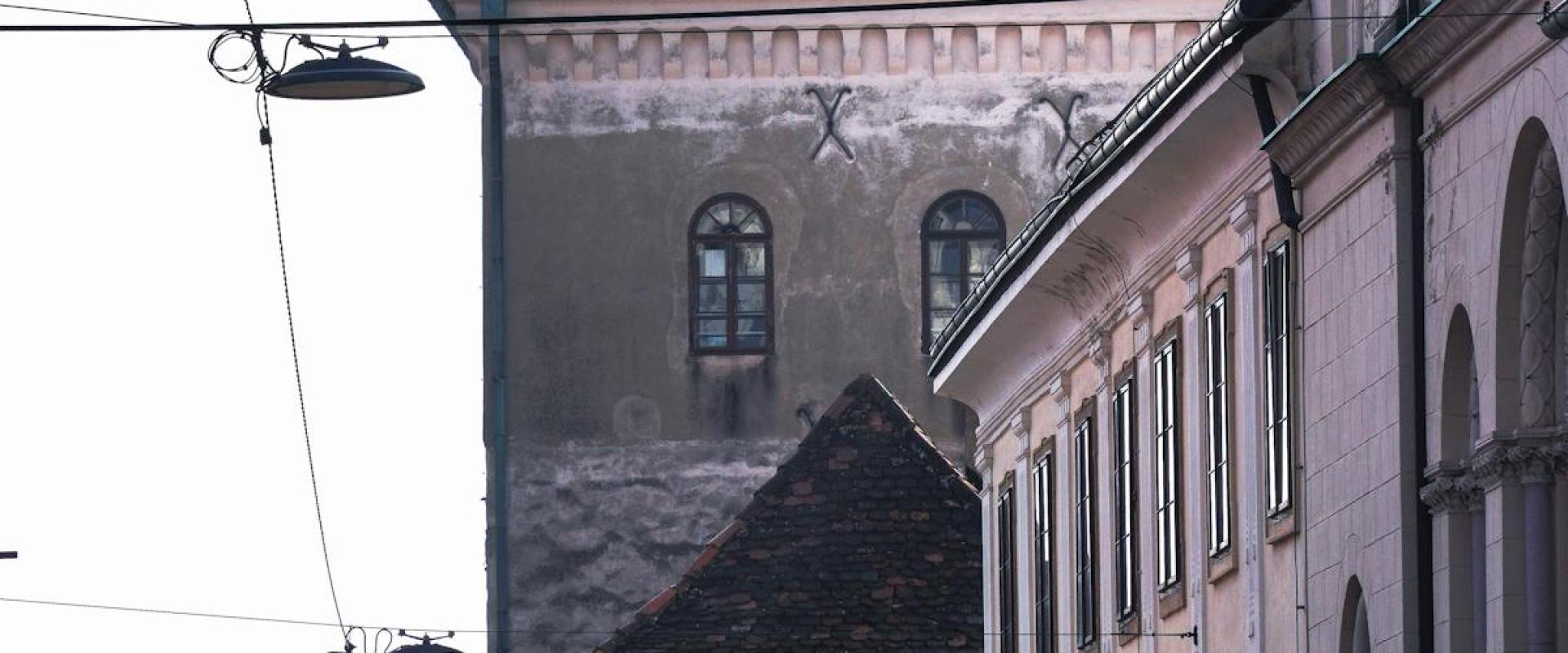 Sunlit street view of historic buildings and architecture in Zagreb, Croatia.