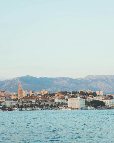 Scenic view of Split's historic architecture with mountains in the background and Adriatic Sea.