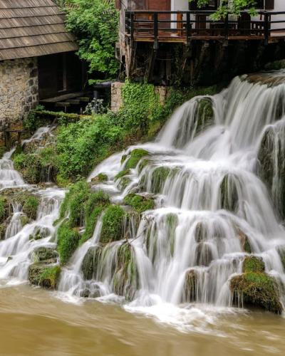 Captivating waterfall next to an old mill in Slunj, showcasing natural beauty and Croatian heritage.