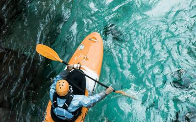 A kayaker paddles through clear turquoise waters, showcasing adventure sports in Croatia.