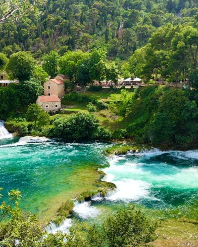 Picturesque view of waterfalls and lush greenery in Krka National Park, Croatia.