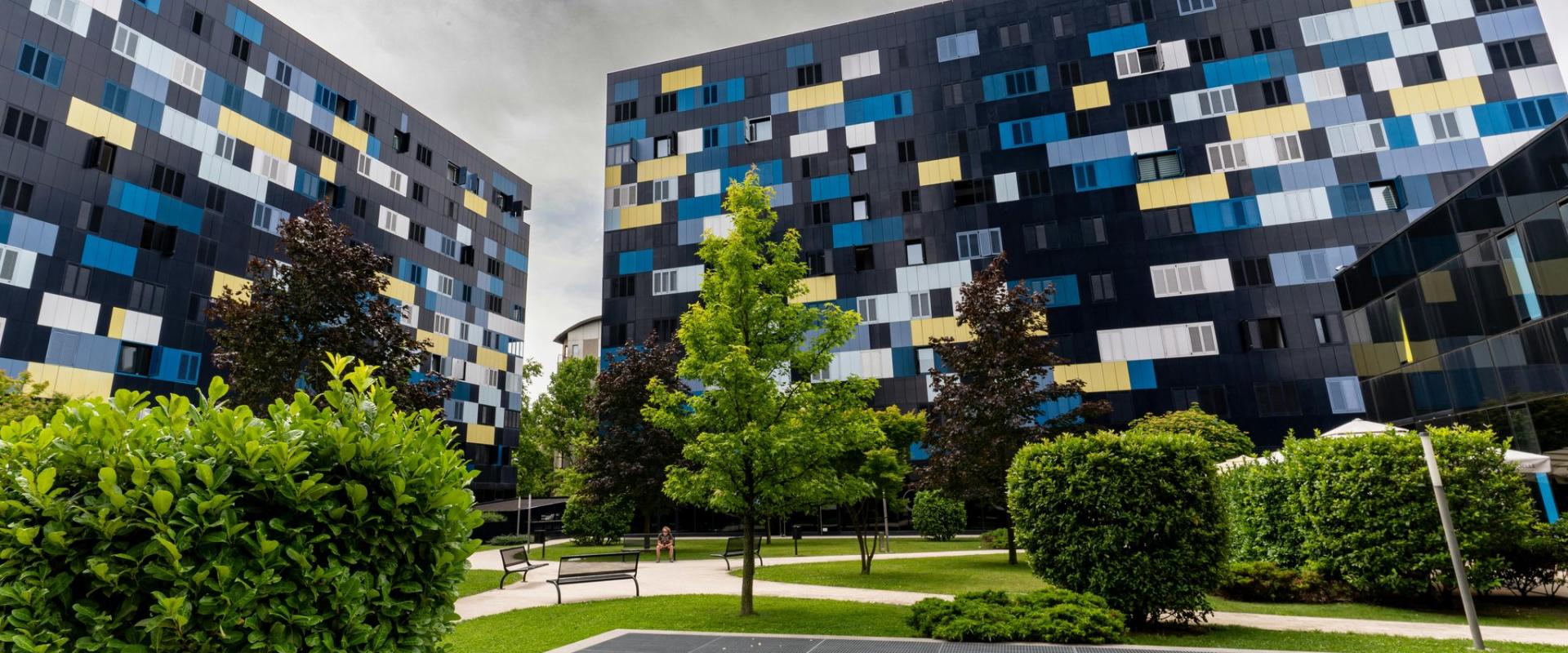 Colorful facade buildings in a green park area, showcasing modern design in Zagreb, Croatia.