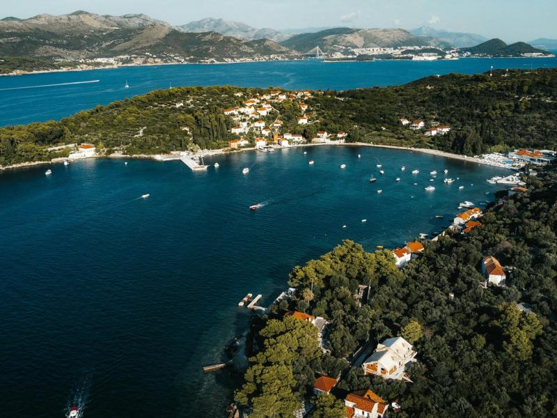 A stunning aerial shot of Koločep Island, Croatia, showcasing the azure waters and lush landscape.