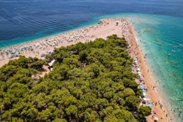 Free Stunning aerial view of the famous Zlatni Rat Beach with turquoise waters, ideal for summer vacations. Stock Photo