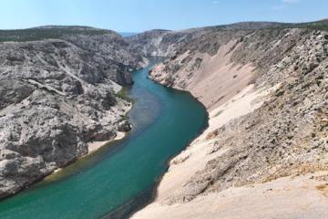 Free Stunning aerial view of the Zrmanja River winding through a rocky canyon under a clear blue sky. Stock Photo