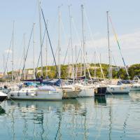 different yachts on body of water under white and blue sky