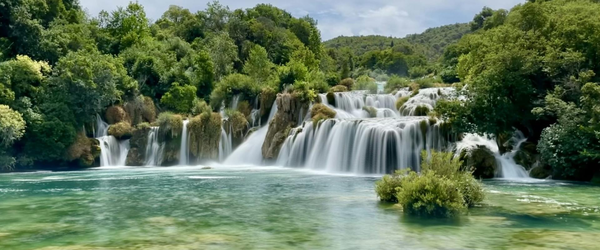 a large waterfall in the middle of a river