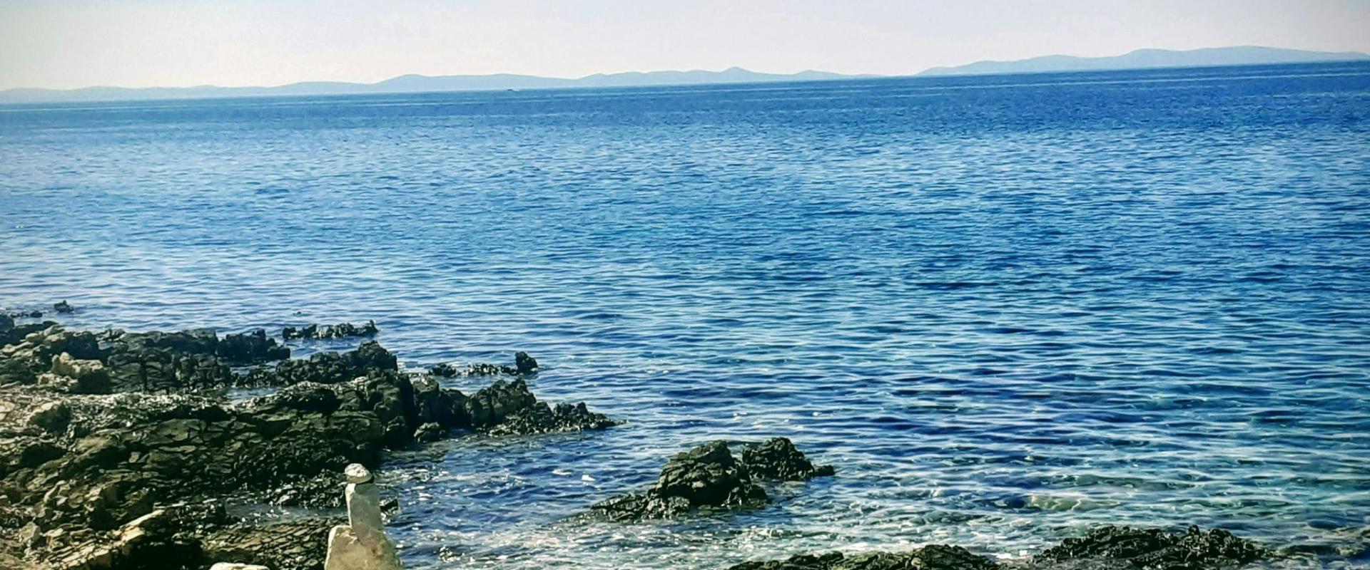 a view of a body of water from a rocky shore