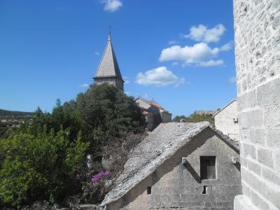Stone houses and church tower in Škrip, home of the Brač Museum