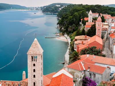 The bell towers of Rab old town above the sea
