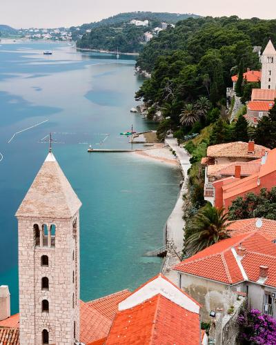 The bell towers of Rab old town above the sea