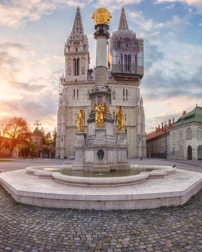 Zagreb Cathedral and the Virgin Mary column fountain at sunrise