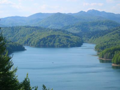 Lokvarsko Lake surrounded by forested mountains in Gorski Kotar