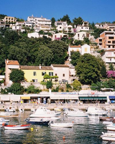 Boats in Rabac harbour below the hillside town