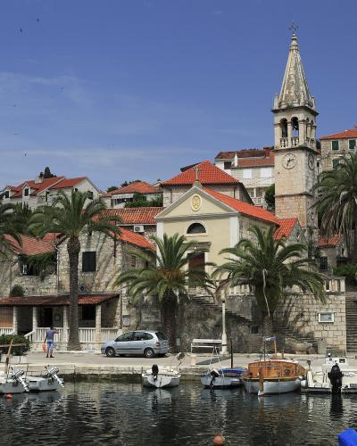 Palm-lined harbour and church tower of Splitska on Brač