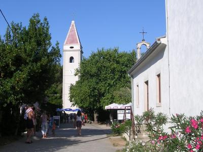 A lane in Silba village with its church towers