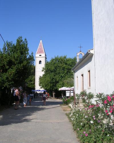 A lane in Silba village with its church towers
